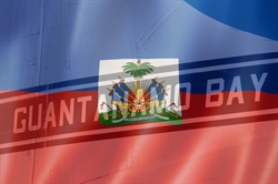 [ai] An artistic overlay of the flags of Haiti and Russia in the background, with the text "Guantanamo Bay" prominently displayed in white across the center.